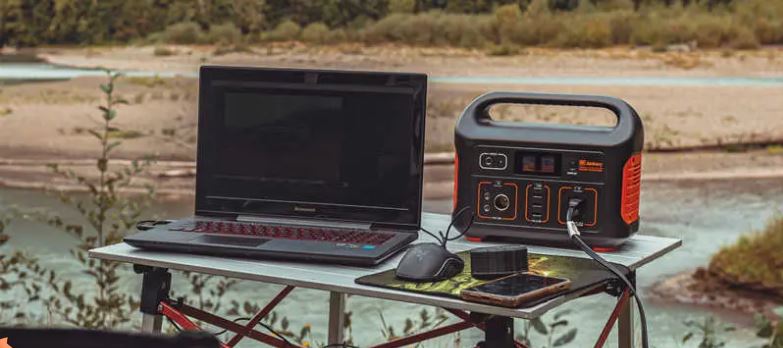 A Jackery Explorer powering a laptop at campsite
